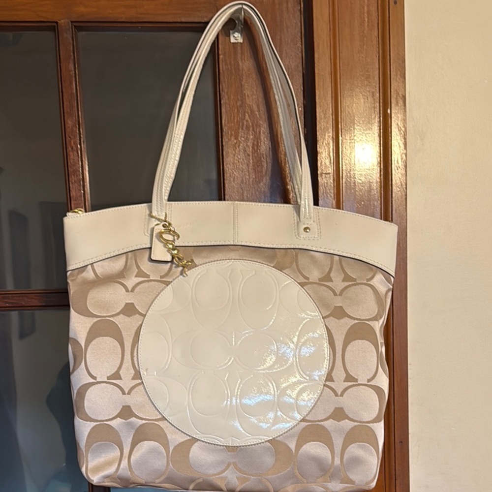 Coach “Laura” khaki and white tote bag.